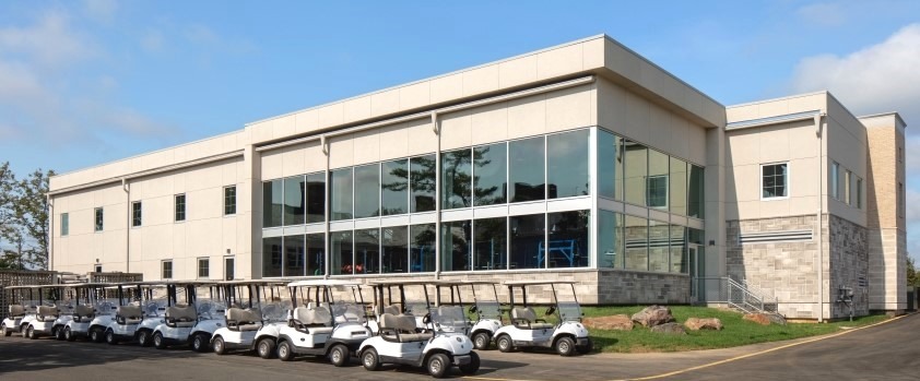 Two-story Butler engineered steel commercial facility with integrated glass façade, illustrating coordinated building system design, durable construction, and efficient site execution.